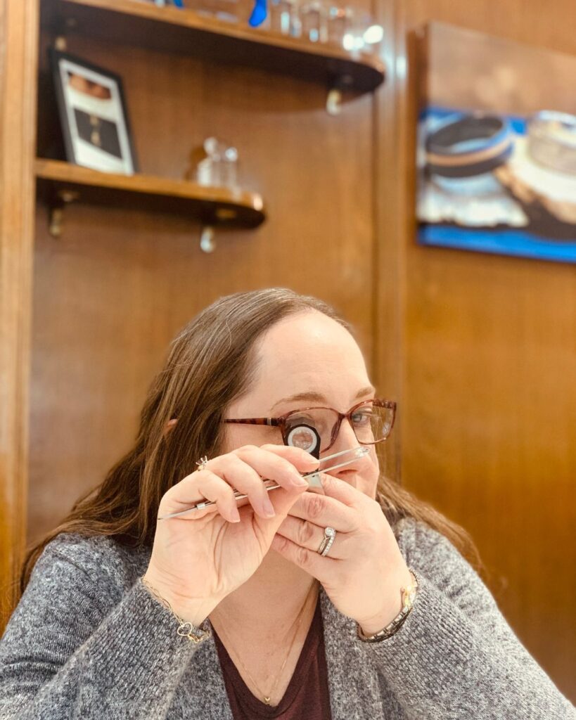 Woman looking at a piece of jewelry for appraisal
